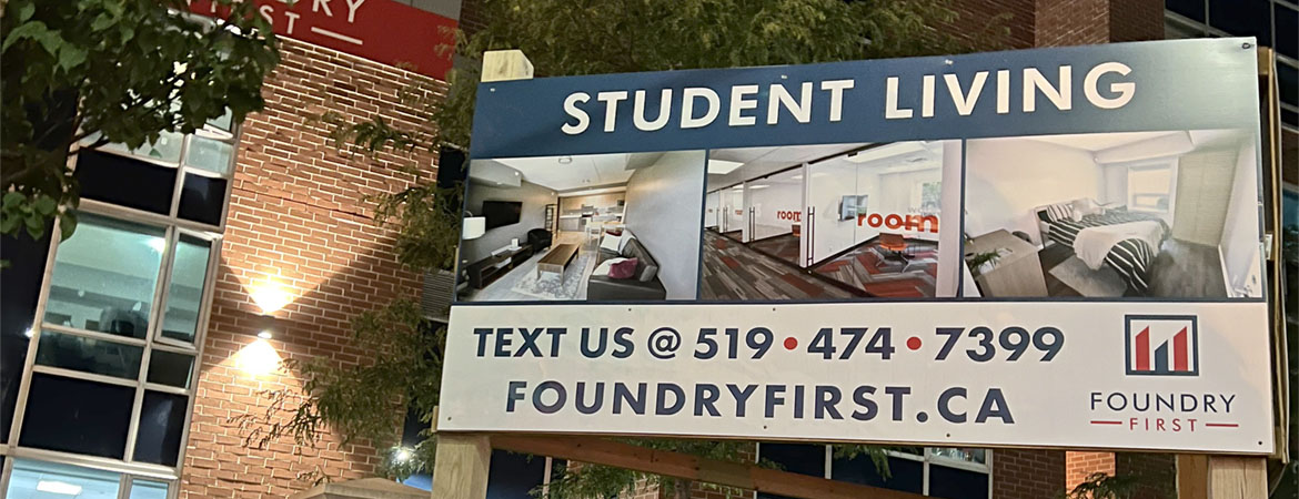Photo of a sign outside the Foundry First building advertising student living in the building.