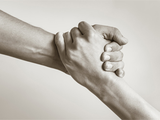 Black and white photo of two hands holding.