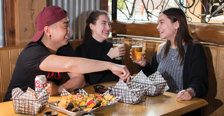 Fanshawe students enjoying food and drinks at The Out Back Shack on campus.