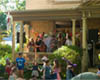 Photo of musicians playing on a porch with children dancing in the yard