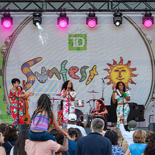 Photo of artists playing on stage at TD Sunfest