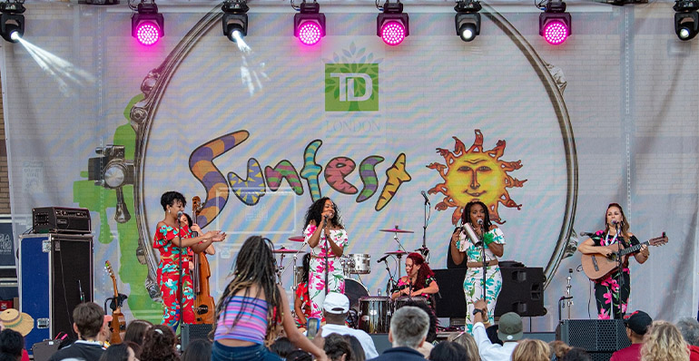 Photo of artists playing on stage at TD Sunfest
