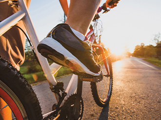 A stock image of someone peddling a bicycle.